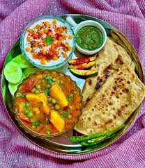 Rajasthani Thali ( Aloo Pyaz Paneer + Gatta + Kadhi +Ker-Sangari + Bejad Roti + Missi Roti + Mirch Tapora + Lehsun Chutney + Rice + Raita + Sweet )